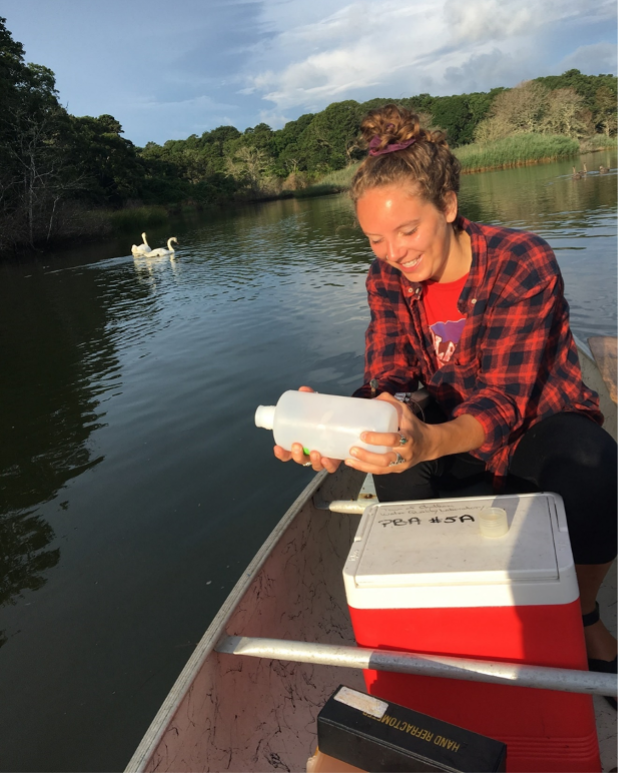 A photograph of a women collecting water tests.